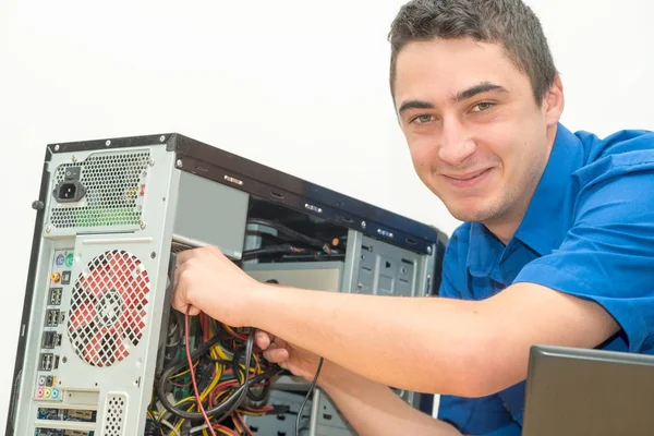 Young technician working on broken computer in his office — Stock Photo, Image