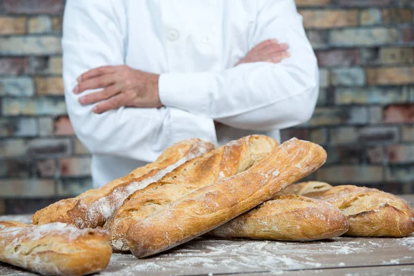 Baker with traditional bread french baguettes — Stock Photo, Image