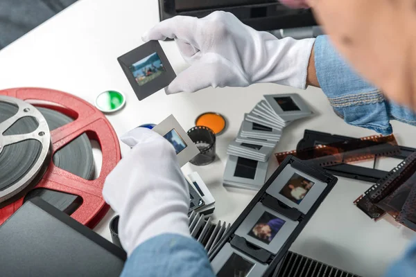 Woman photographer looking at film slide — Stock Photo, Image