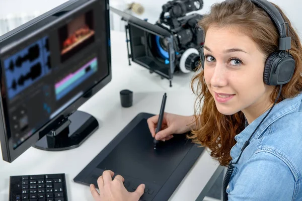 Young woman designer using graphics tablet for video editing — Stock Photo, Image