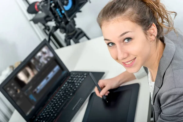 Young woman designer using graphics tablet for video editing — Stock Photo, Image