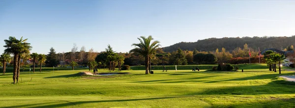 green golf field and blue  sky