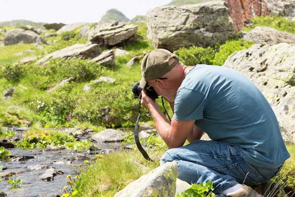 Turistu s kamery fotografování snímku malý potok — Stock fotografie