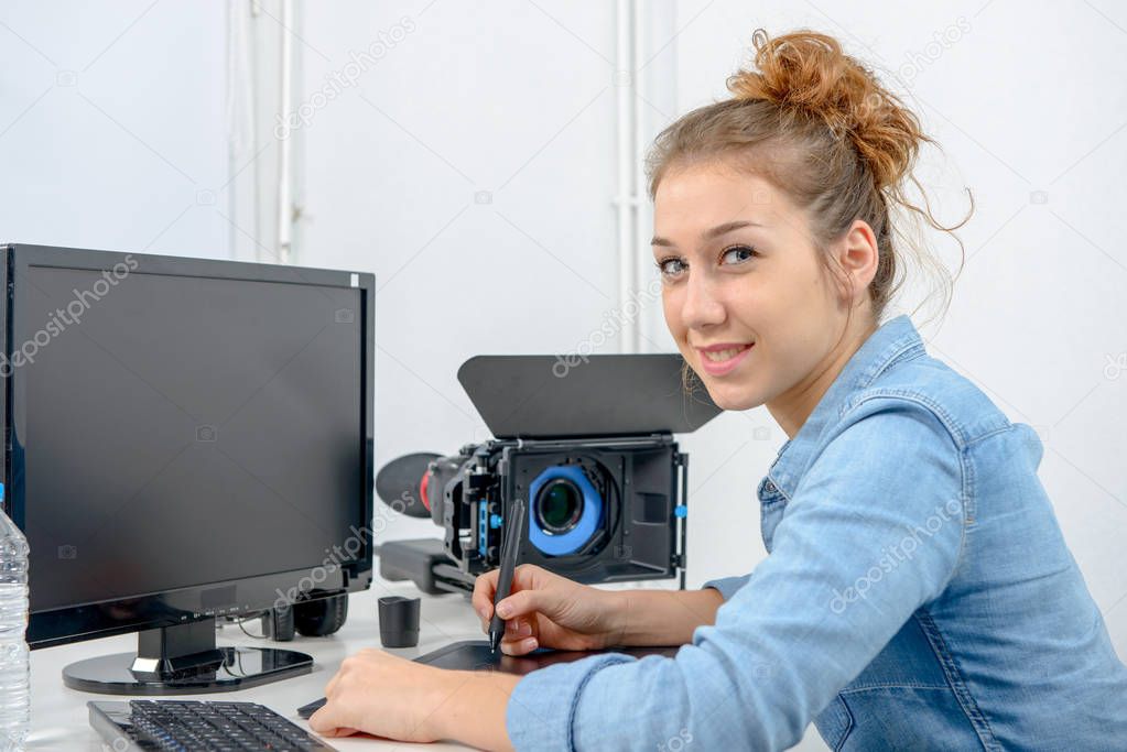 young woman designer using graphics tablet for video editing