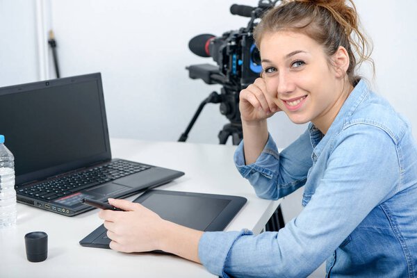 young woman designer using graphics tablet for video editing
