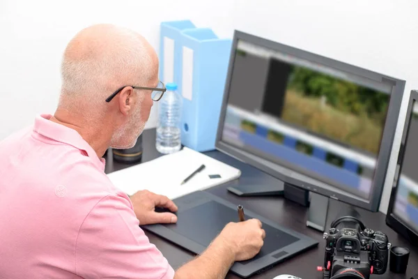 Mature man working with graphics tablet in his office — Stock Photo, Image