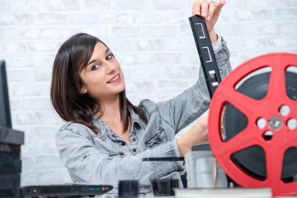 Pretty young technician scanning film slide — Stock Photo, Image