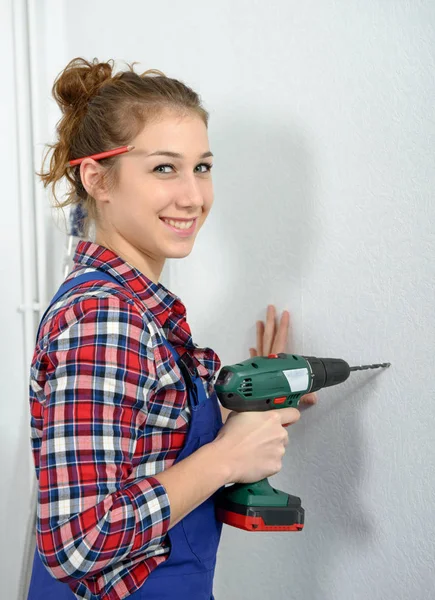 Pretty young woman holding cordless drill — Stock Photo, Image