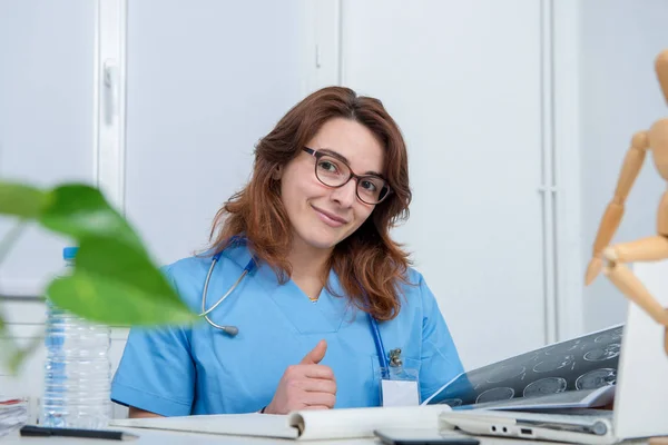 Portrait of young female doctor in his office — Stock Photo, Image