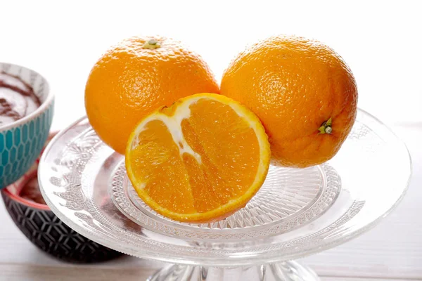 Close up of oranges in a glass dish — Stock Photo, Image