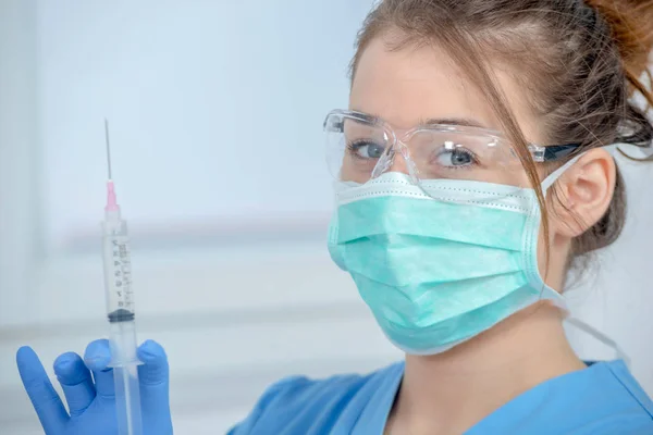Ung sjuksköterska förbereder injektion med spruta i sjukhus — Stockfoto