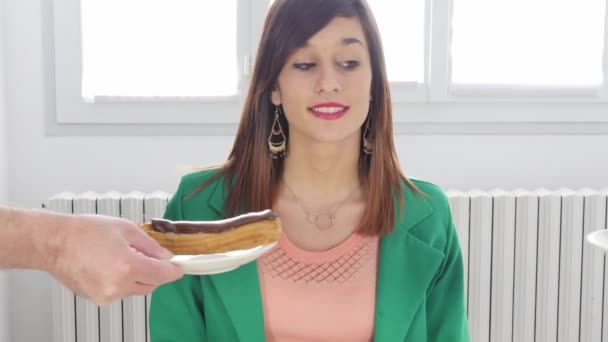 りんごとチョコレート菓子の間を選択する若い女性 — ストック動画