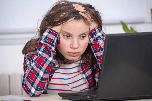 Bored teenage girl is doing her homework — Stock Photo, Image