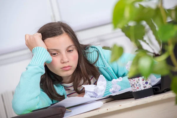 Bored teenage girl is doing her homework — Stock Photo, Image