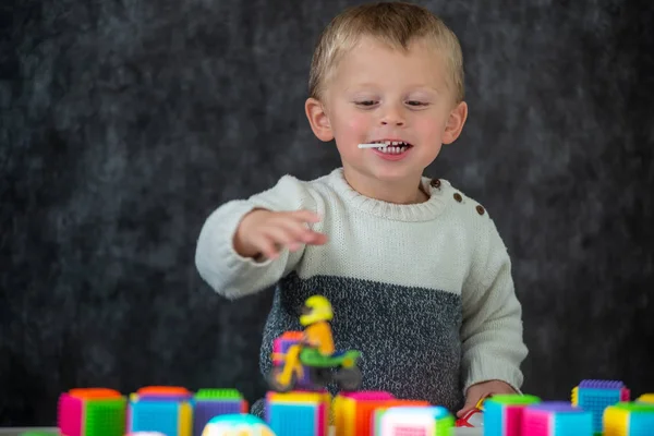 Portret van schattig jongetje spelen met motorfiets speelgoed — Stockfoto