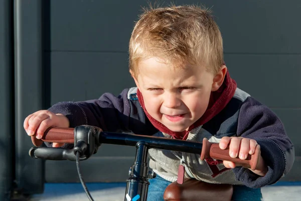 Barn två år gammal leka med en cykel — Stockfoto