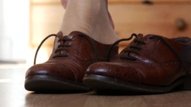 Close-up hands of woman tying shoelace
