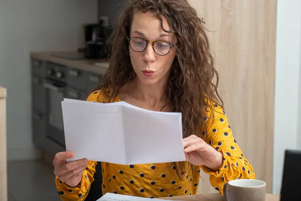 Young woman looking at received mail at home — Stock Fotó