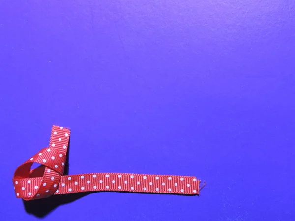Gift ribbon and festive bow on different backgrounds.
