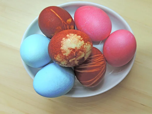 Easter cake and colored colored eggs. Traditional Easter spring holiday food on the background of a wooden table.