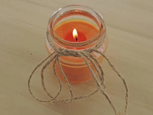 aromatic candle in a jar on a light background.