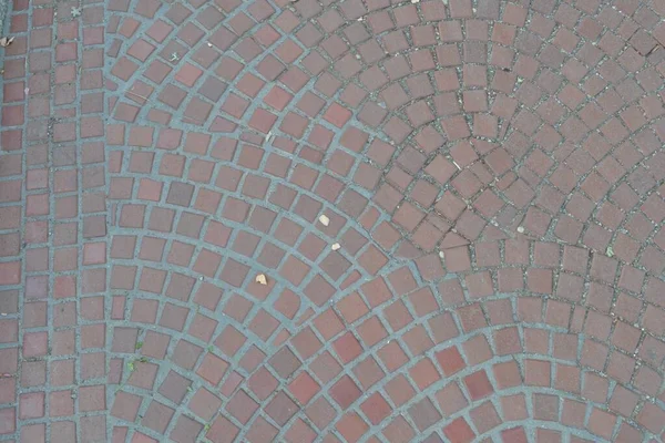 Sidewalk tiles for city streets laid out in a circular way. Technology is paving