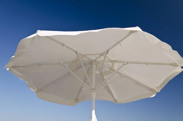 Beach umbrella against the blue clear sky on the beach