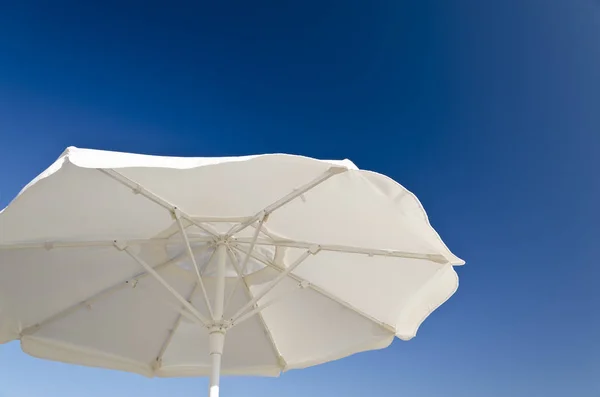 Beach umbrella against the blue clear sky on the beach