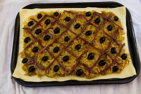 Французский анчоусовый, оливковый лук пирог pissaladiere сырой — стоковое фото