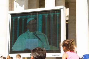 Pope Francis giving Papal Audience on large screen  clipart