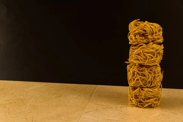 Stack of noodle nests, with copyspace. — Stock Photo, Image