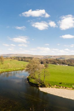Nehir, uzak tepeler ve bahar gününde bulut.