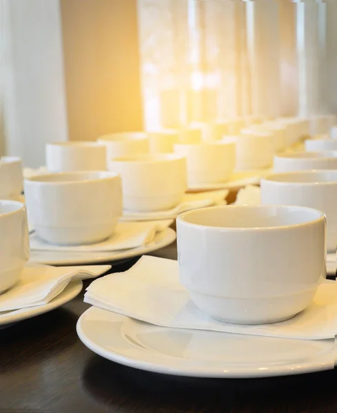 Muchas tazas de café blanco a la espera de servir con luz caliente ef — Foto de Stock