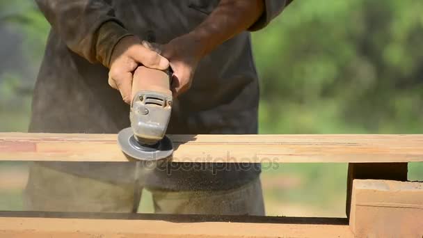 Joiner works with an electric scrubber and processes wooden products.Carpenter with handheld electric scrubber   in the hands on the woodwork. — Stock Video