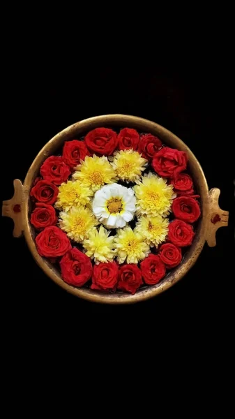 Indian flower decoration in holy water. It's a Hindu religion to pray to the god with the beautiful flower decoration