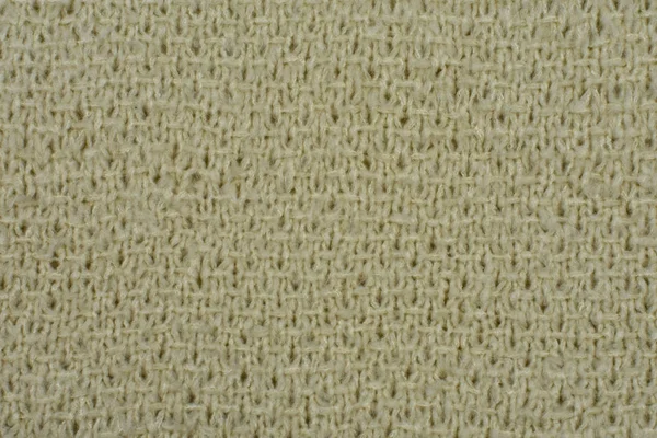 Close-up van gebreide beige wollen textuur. — Stockfoto