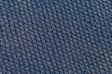 Arka plan olarak örülmüş desen. Örgü desenli yakın çekim. Tekstil arkaplan mavisi tonu.
