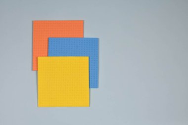 Temizlik konsepti. Mavi arka planı temizlemek için çok renkli paçavralar. Temizlik kavramı. Geçmişi. Kartpostalın temeli. Yukarıdan görüntüle.