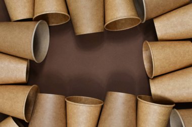 Sıfır atık. Kahverengi arka planda kağıt bardaklar. Yazı için uygun bir yer. Yukarıdan görüntüle