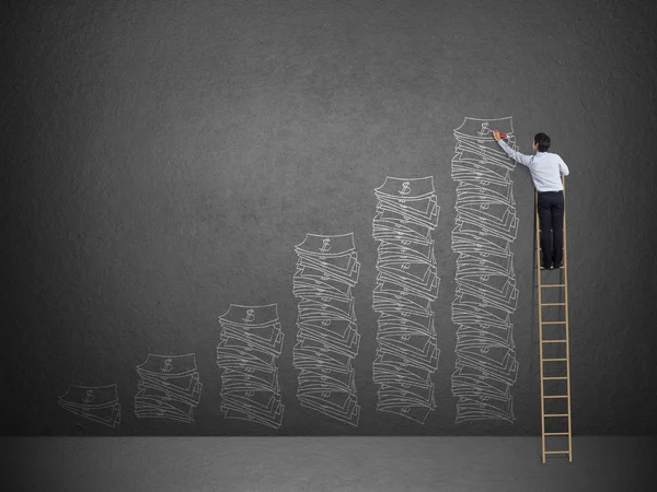 Business man on ladder drawing idea is money concept on wall — Stock Photo, Image