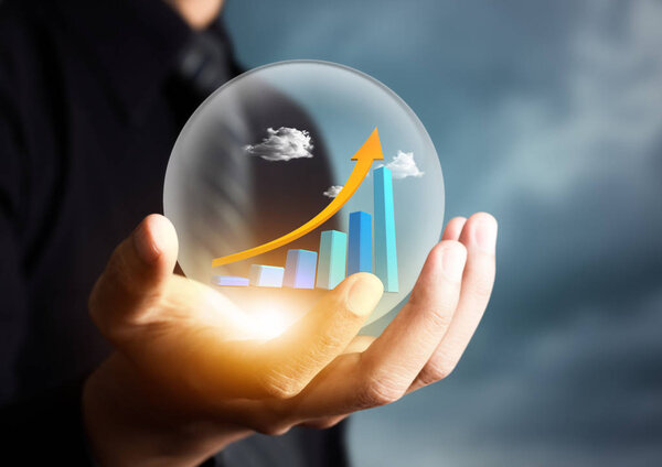 businessman holding increasing graph in crystal ball