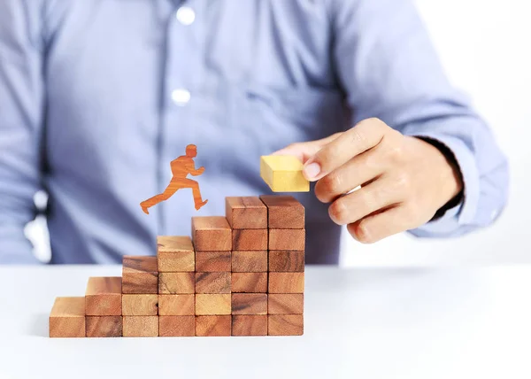 businessman climb up on stair to goal