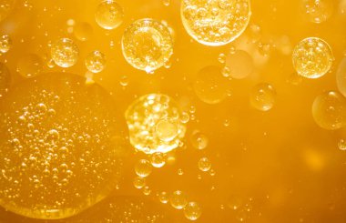 Altın sarısı baloncuk yağı ya da serum, Soyut Sarı su kabarcıkları arka plan