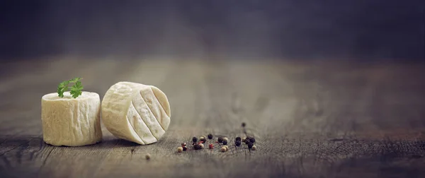 goat cheese on a wooden table, banner