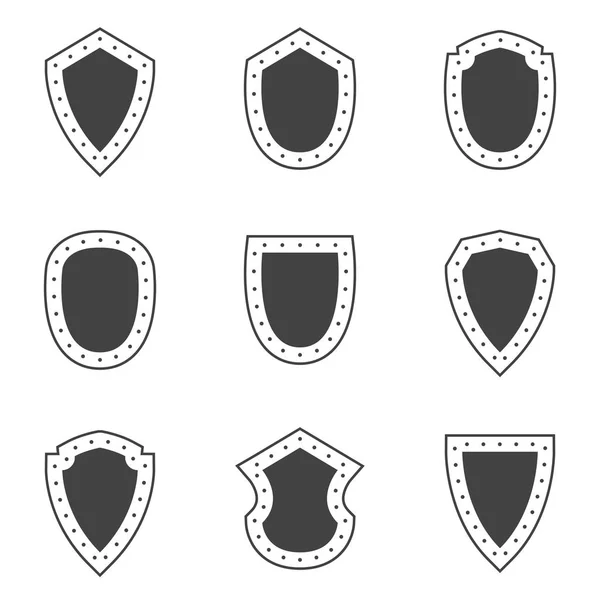 Vektor schwarze Schilde auf weißem Hintergrund — Stockvektor