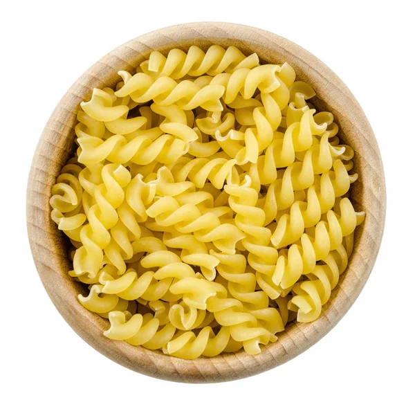 Portion of Rotini corkscrew pasta in wooden bowl. Uncooked dried durum wheat semolina — Stock Photo, Image