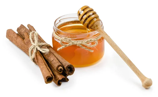 Canela olla de miel sobre un fondo blanco aislado — Foto de Stock