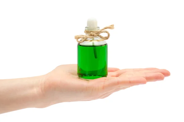 Vrouwelijke hand neemt of geeft handgemaakte aroma olie. — Stockfoto