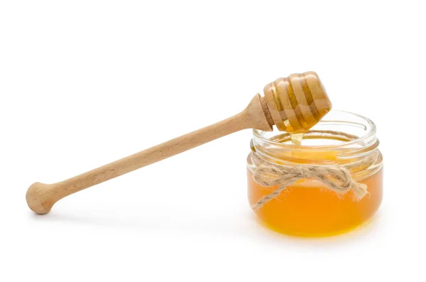Tarro con miel y cuchara de miel . — Foto de Stock