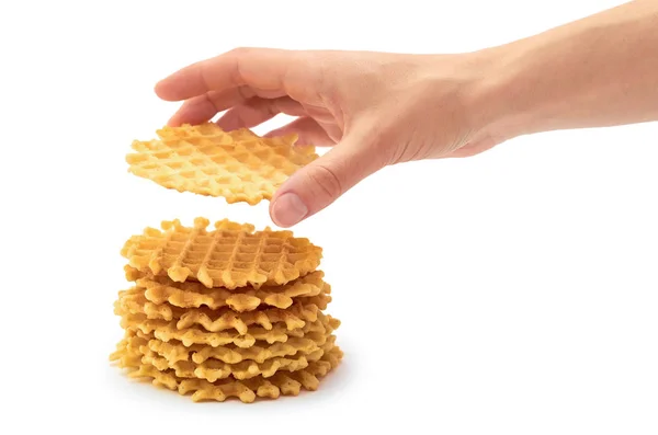 Vrouwelijke hand houdt zelfgemaakte scherpe wafel. geïsoleerd op witte achtergrond — Stockfoto